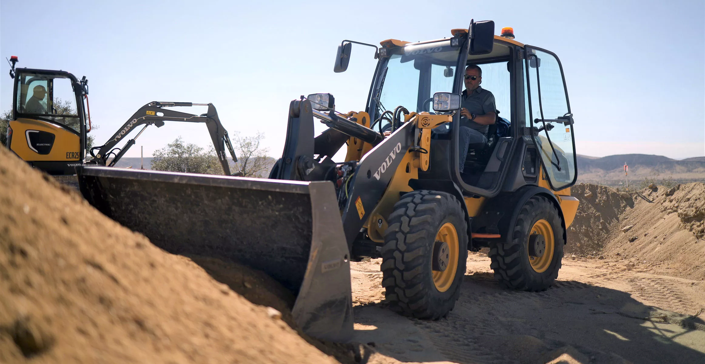 The ECR25 Electric compact excavator (left) and the L25 compact wheel loader (right) are up for pre-order now