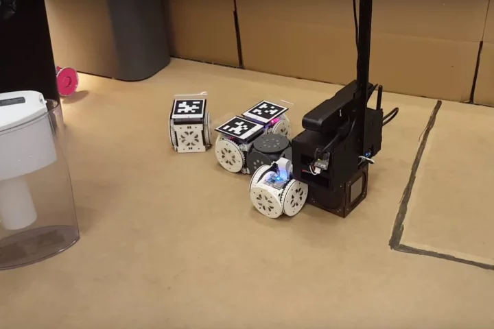 In one experiment, the modular robot system was tasked with finding and retrieving a pink object, and then delivering to a designated dropoff zone