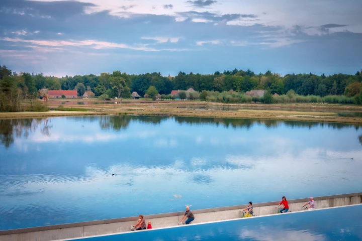 Cycling Through Water is a 200-meter bike path that cuts through a pond as part of a larger route network in Limberg, Belgium