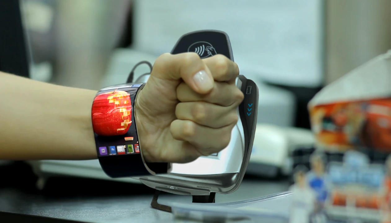 The upper screen auto activates as the arm is raised, while the lower screen turns on when it's pointed upwards by twisting the wrist