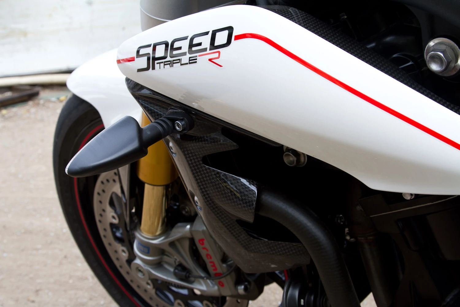 Triumph's Speed Triple R - the side covers and headlights are among the only visual distractions from pure two-wheels-and-a-seat motorcycling.