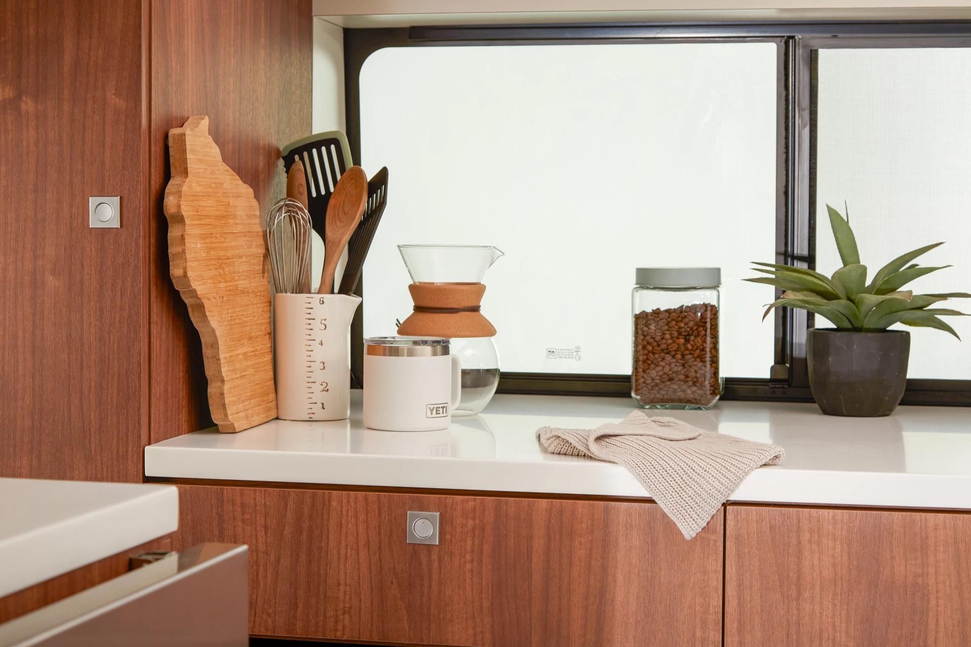 The central driver side of each ProCamp van is filled out by a large cabinet unit with worktop and full-height wardrobe