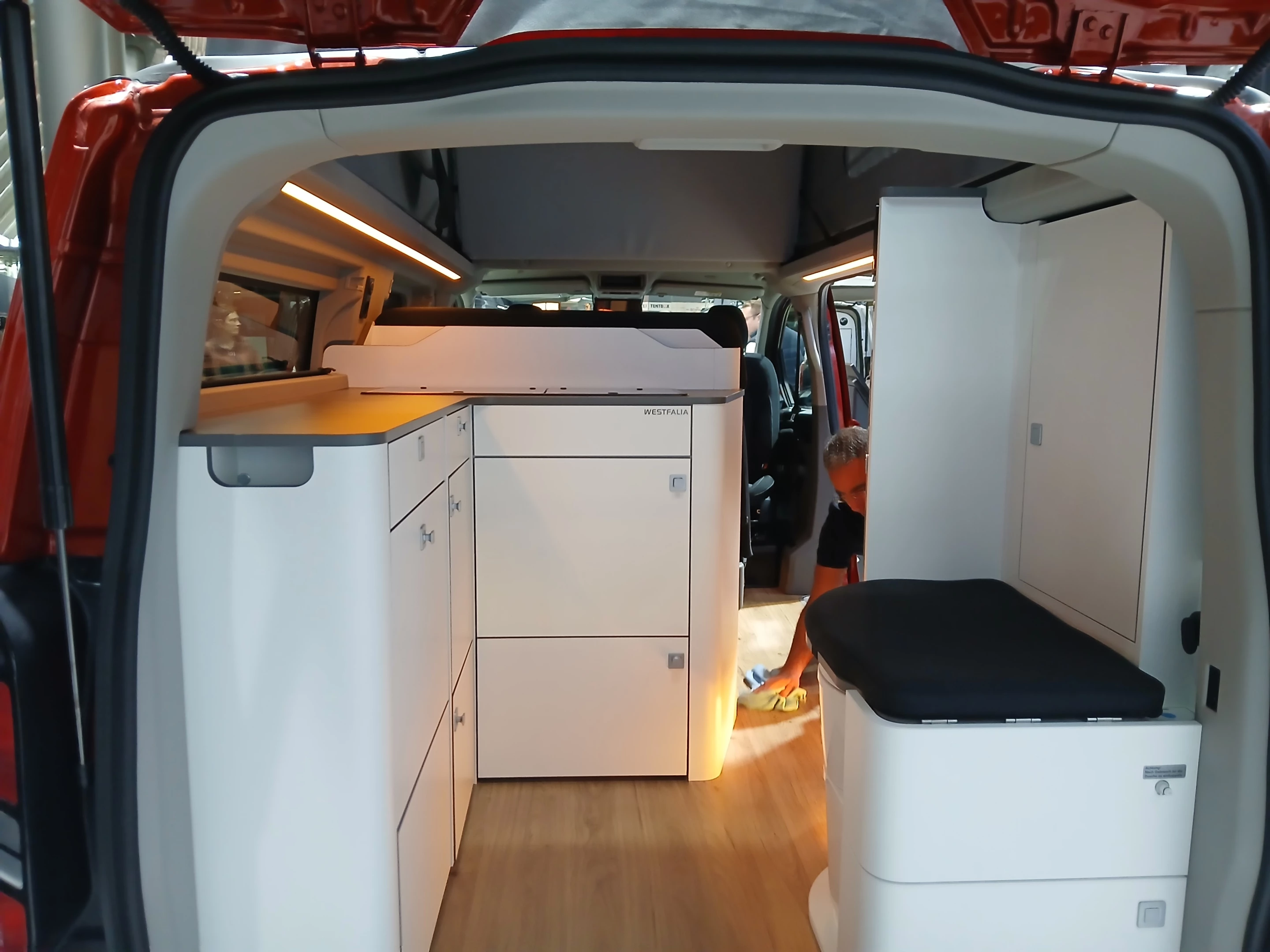 This bright-orange Ford Nugget includes a compact rear toilet area to take care of one more essential function on the road