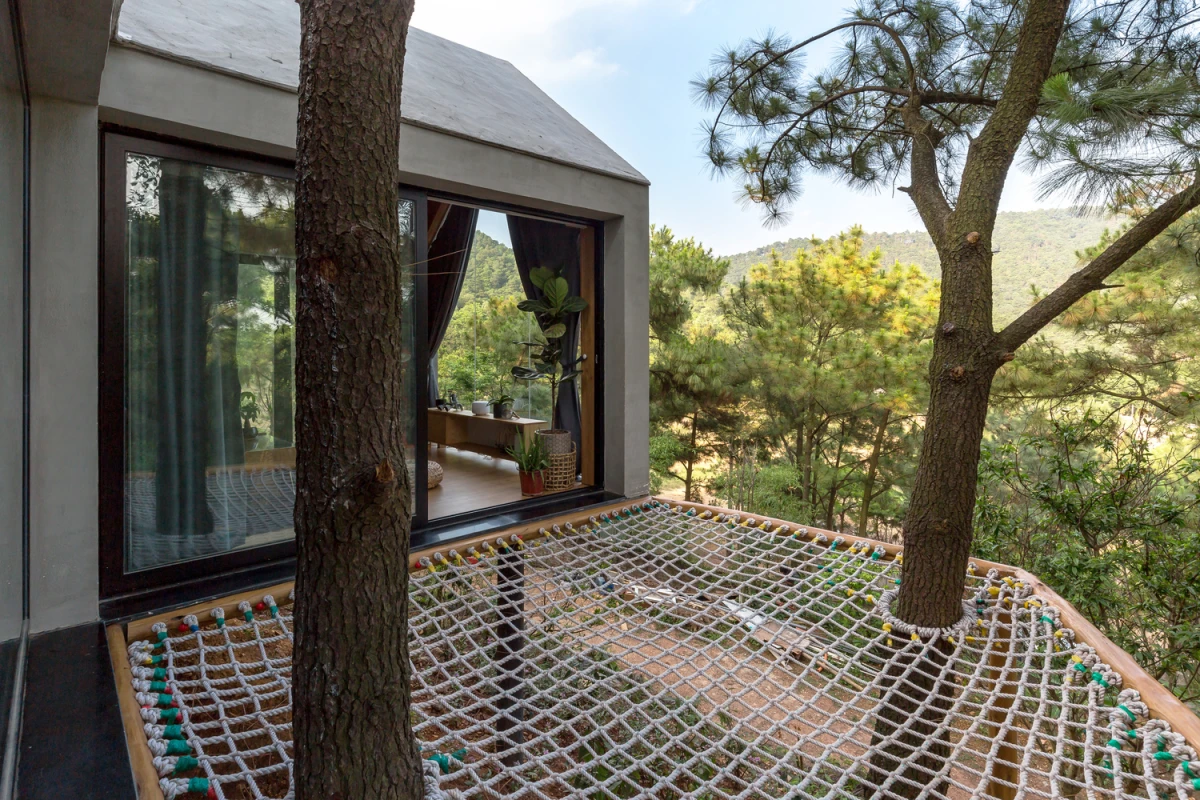 Forest House 02 is surrounded by vast forest landscape in the Sóc Sơn District, 30.6 km (19 mi) outside of Hanoi, Vietnam