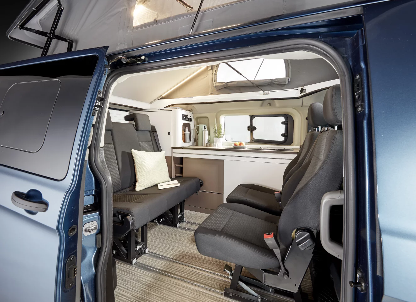 Two-seat bench and individual seats in a business van-like vis-a-vis layout