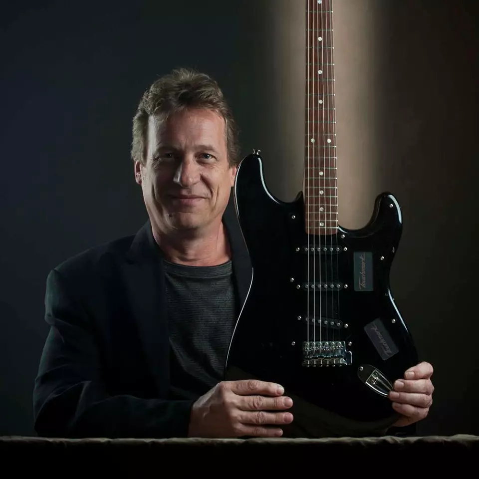 Los Angeles industrial designer and keen guitarist Mark Andersen with his Touchmark Guitar