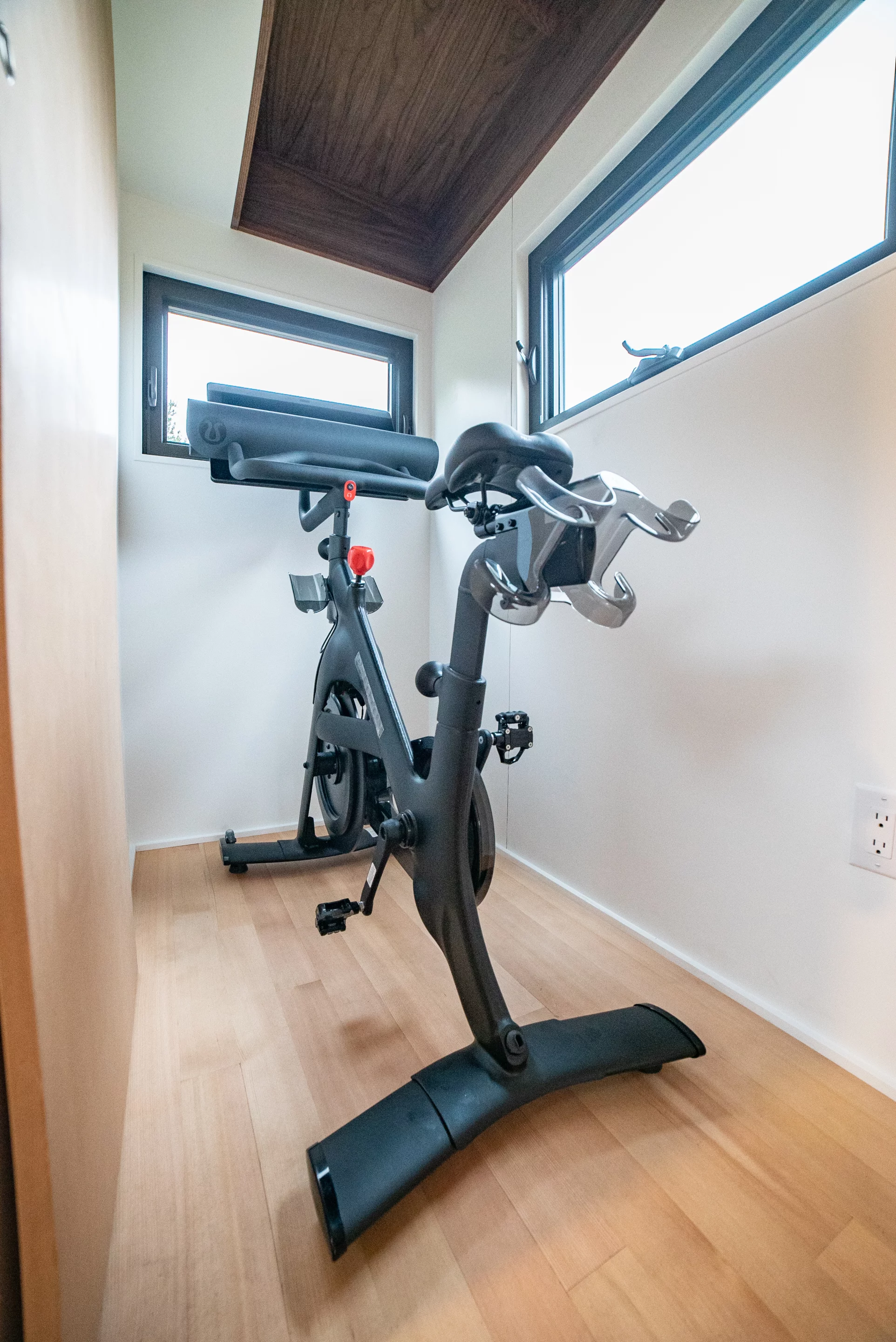 The Trahan Tiny House's gym has a raised ceiling so that the owner can stand while using the exercise bike