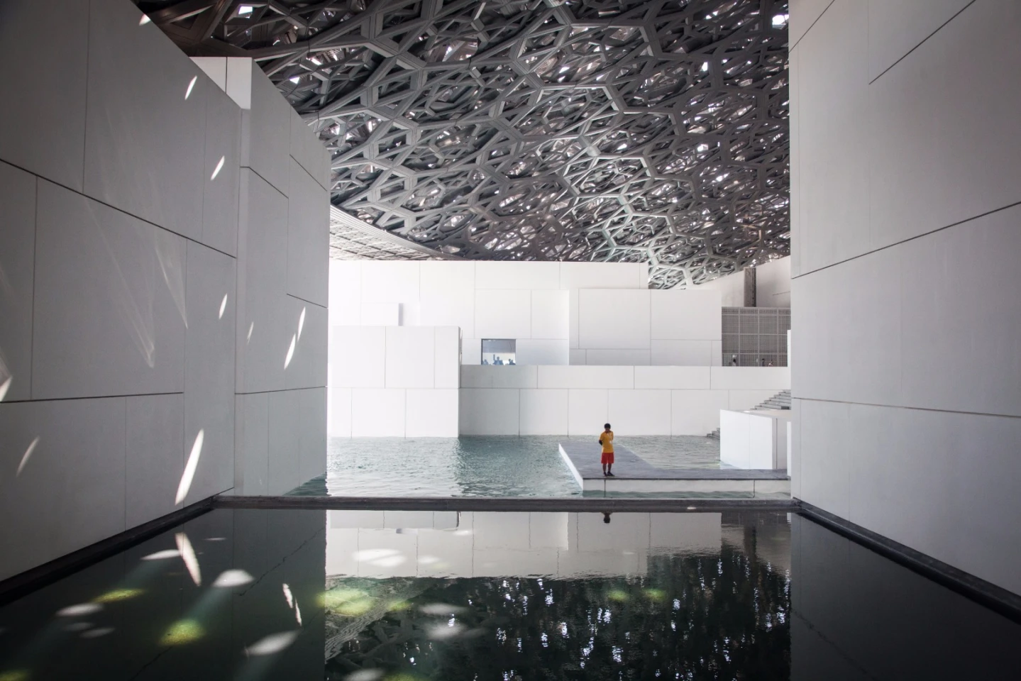 The dome is made up of eight separate layers of stainless steel and aluminum mesh, which combine to form a tapestry of 7,850 geometric holes for the sun to filter through