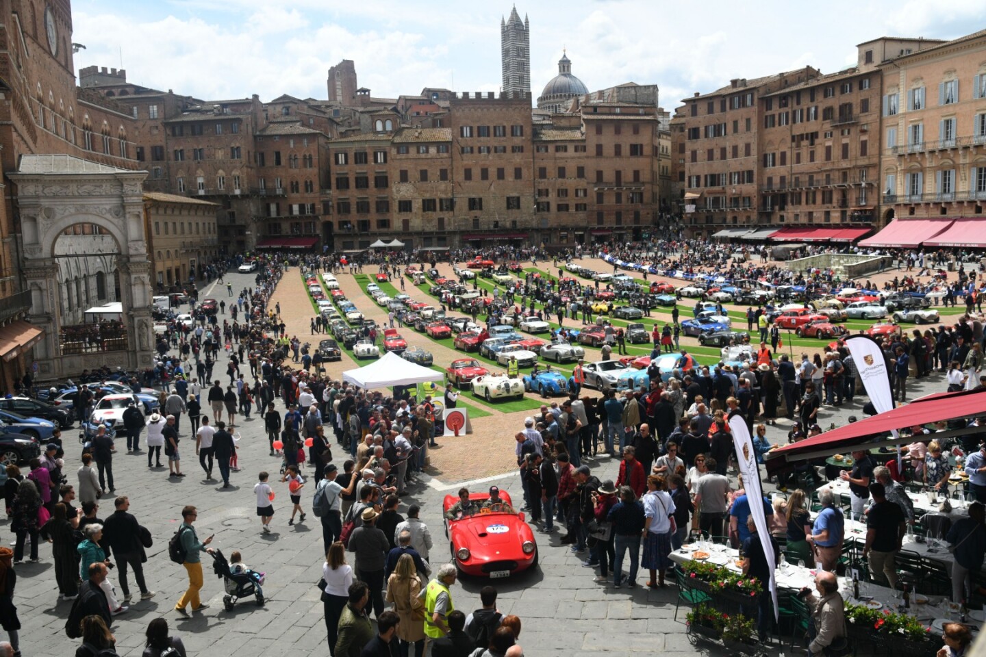 Hundreds of millions of dollars' worth of cars line up in a beautiful European town square