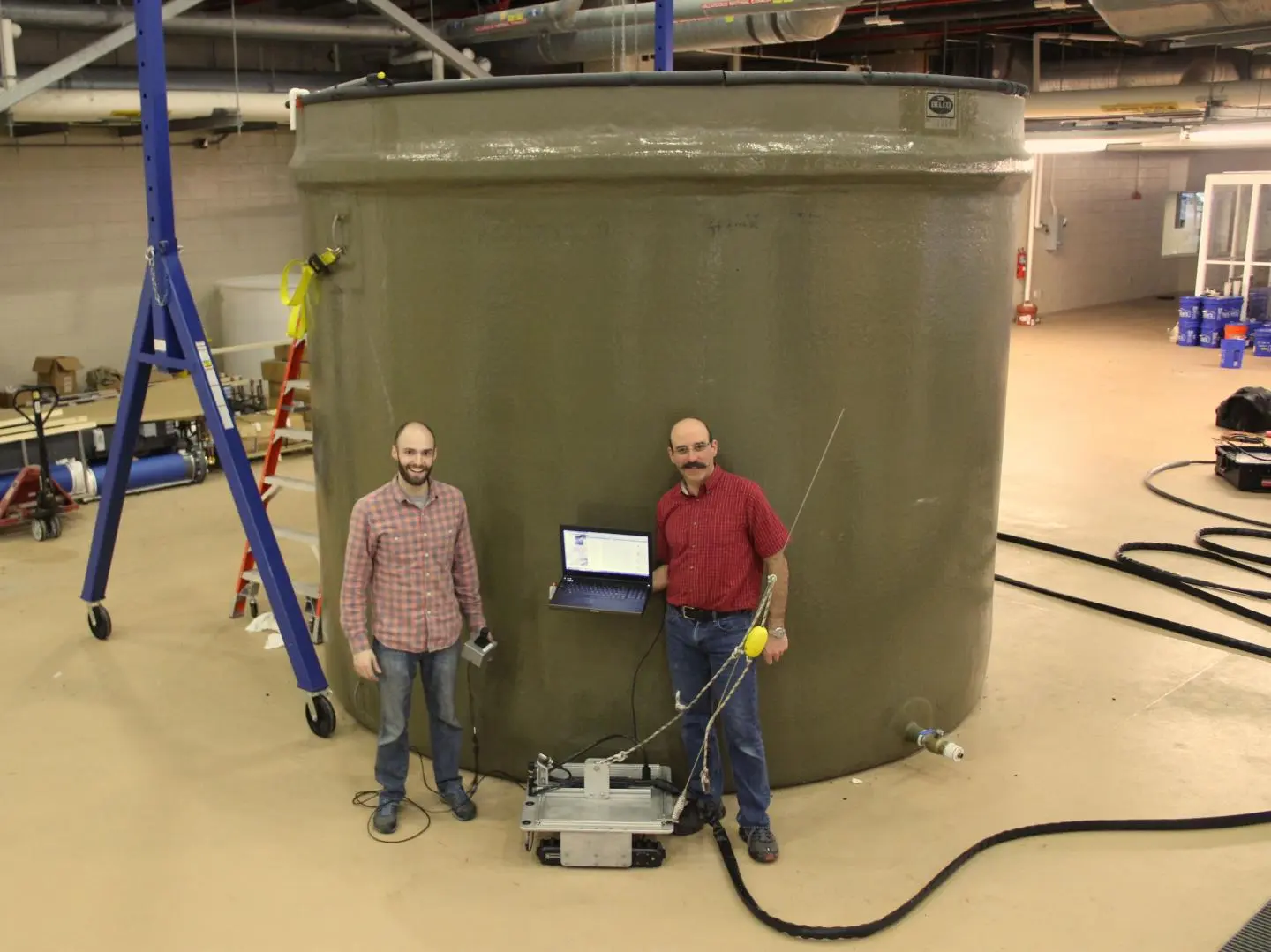 Paul Panetta (right) and colleague Dale McElhone with the Acoustic Slick Thickness ROV, in front of a testing tank (Photo: VIMS)