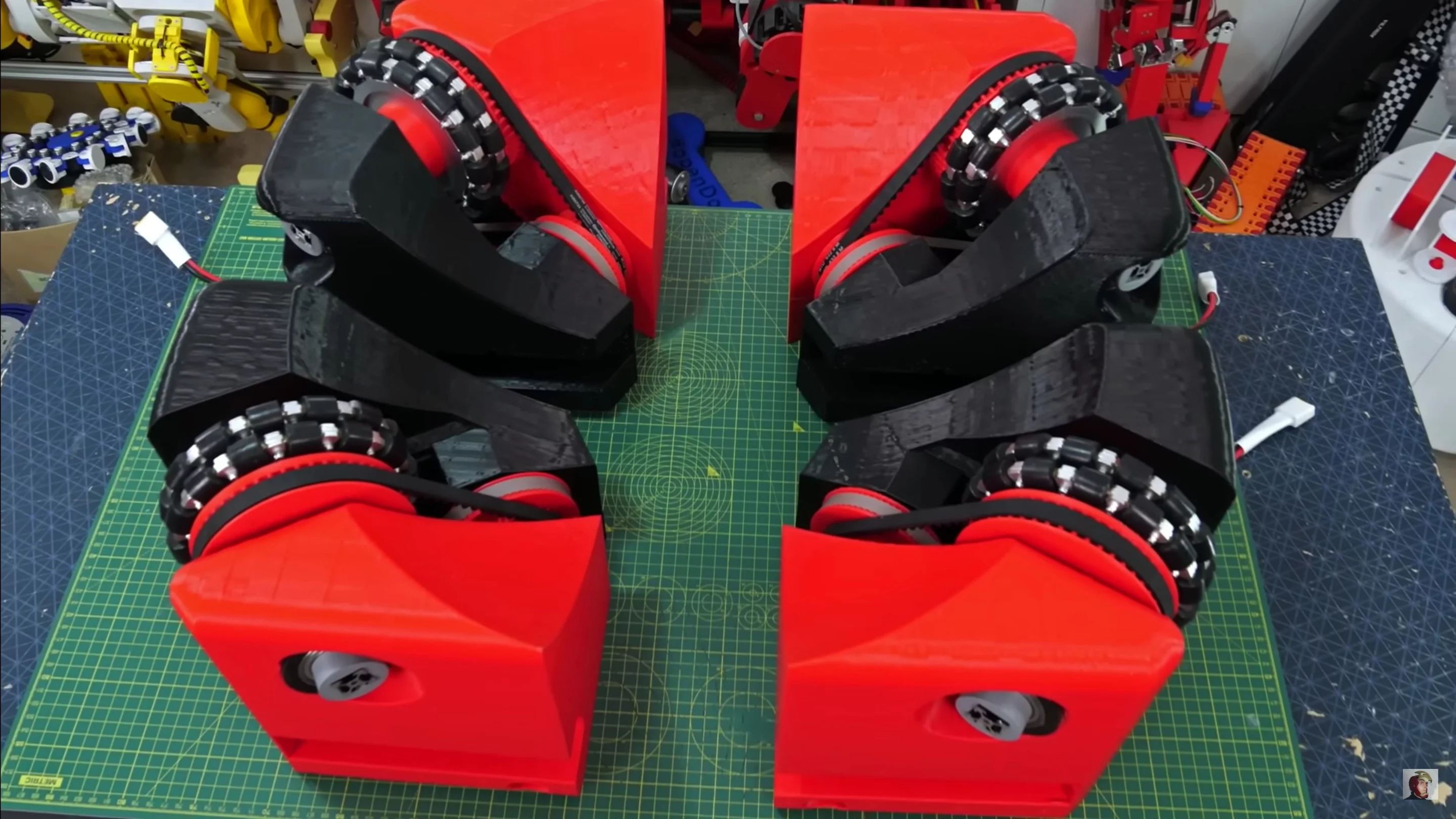 Four of the belt-driven omnidirectional wheels built into modules to be installed to the chassis
