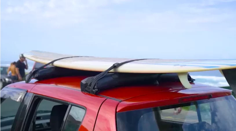 The Tair roof racks with a surfboard attached