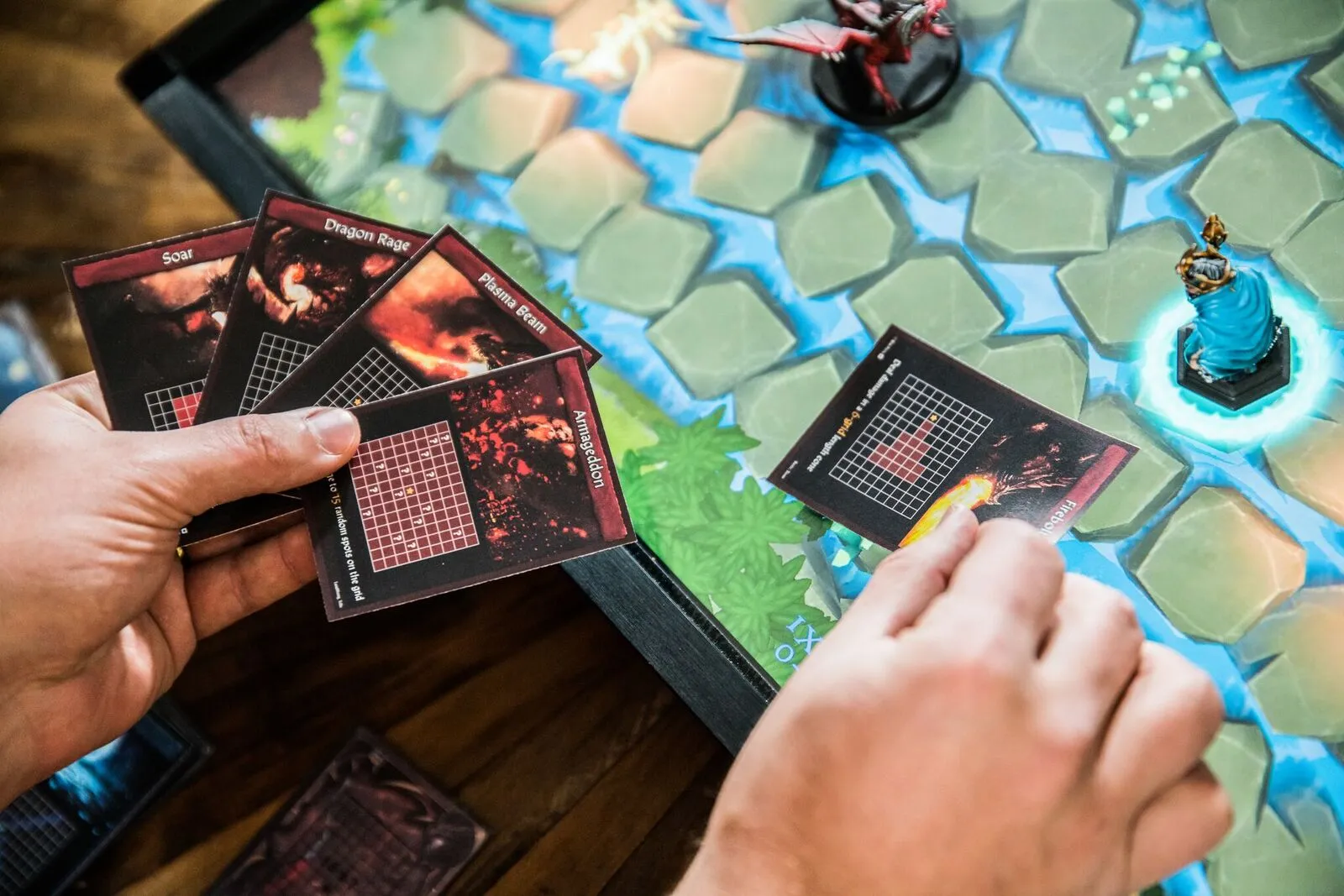 Physical game pieces can be moved across the PlayTable board, leveled up and learn new skills