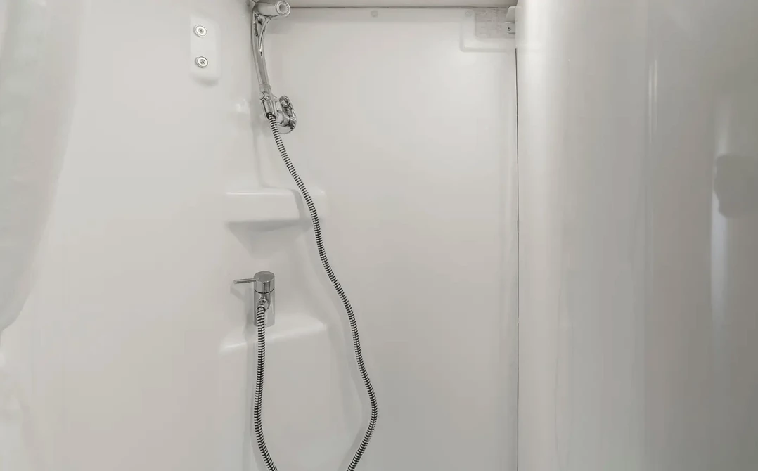 When one swivels the sink wall around over the toilet, it reveals the full shower hiding behind it