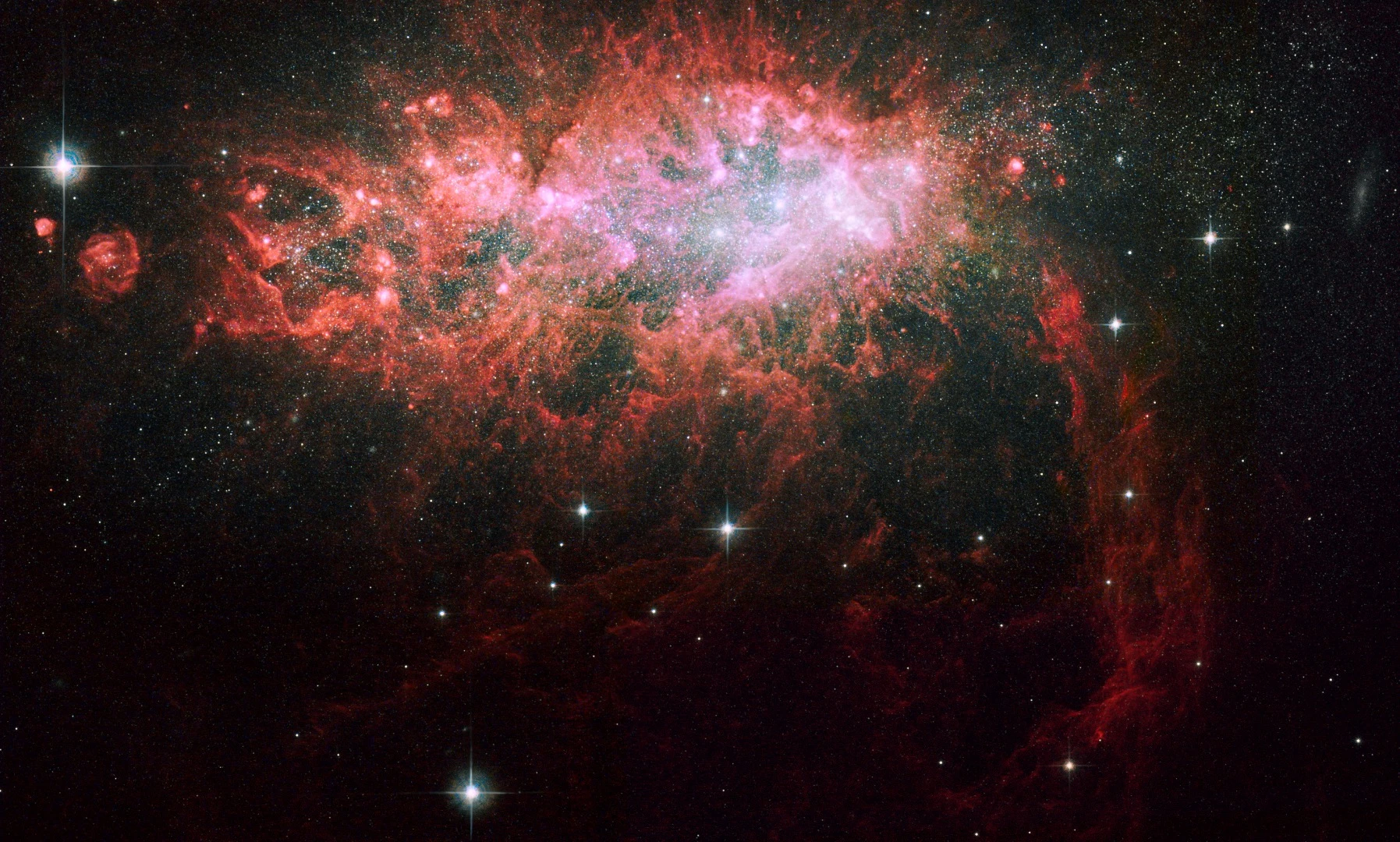The galaxy, called NGC 1569, sparkles with the light from millions of newly formed young stars. NGC 1569 is pumping out stars at a rate that is 100 times faster than the rate observed in our Milky Way Galaxy (Credit: Credit for Advanced Camera Data: NASA, ESA, A. Aloisi (STScI/ESA), J. Mack and A. Grocholski (STScI), M. Sirianni (STScI/ESA), R. van der Marel (STScI), L. Angeretti, D. Romano, and M. Tosi (INAF-OAB), and F. Annibali, L. Greggio, and E. Held (INAF-OAP) Credit for Wide Field Planetary Camera 2 Data: NASA, ESA, P. Shopbell (California Institute of Technology), R. Dufour (Rice University), D. Walter (South Carolina State University, Orangeburg), and A. Wilson (University of Maryland, College Park))