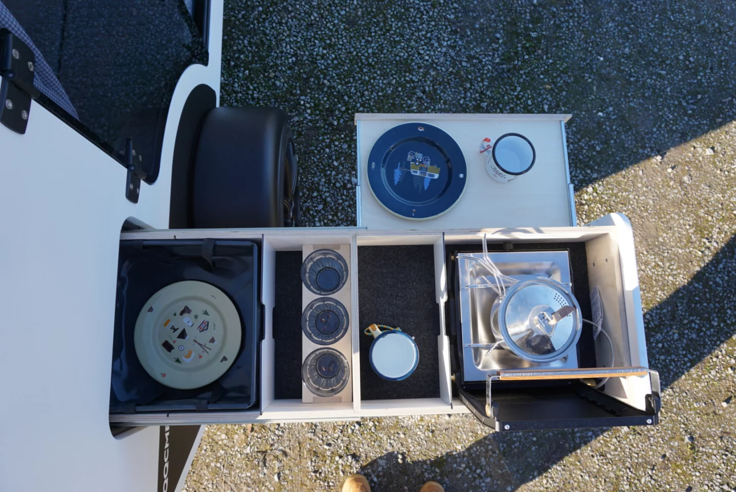 Overhead of the Kuckoo Emma's indoor/outdoor kitchen slide, a feature derived from the larger Bruno trailer