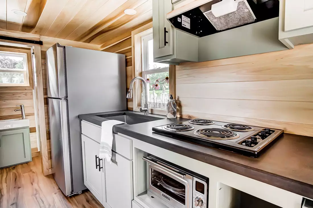 The Clover's kitchen includes a four-burner stove top, convection oven, fridge/freezer, washer/dryer, sink, and breakfast bar