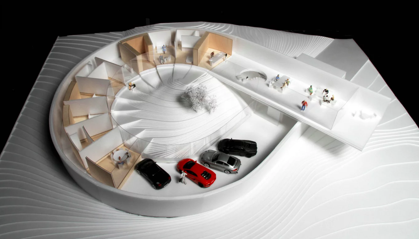 The looping Villa Gug design by the Bjarke Ingels Group (BIG) integrates the cars into the main body of the house