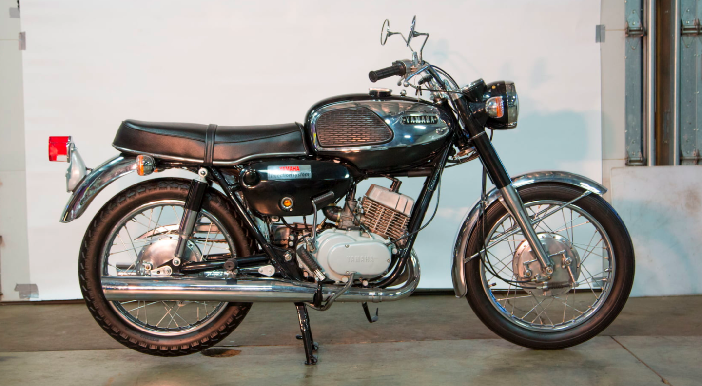 Though there have been several much lauded Grand Prix replica road bikes in recent times, the Yamaha YR1 Grand Prix twin of 1967 was probably as close technologically to the 350cc two-stroke twin cylinder racers produced by Yamaha, as the more recent bikes of Ducati and Honda were to their Grand Prix counterparts. In 1968, Yamaha's 350 cc road racing bikes (with engines almost identical to this bike) shocked the American public by finishing second and third in the country's most important road race, the Daytona 200 Miles, against a field of unlimited capacity machines. In 1969, a Yamaha 350 was the first to lap the Daytona circuit at 150 mph.