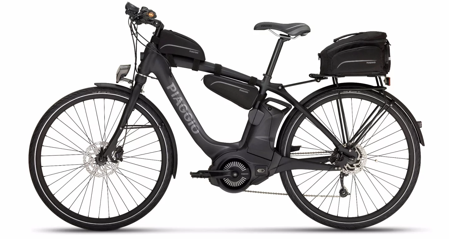 An Active Wi-Bike with accessories including top tube bag, rear rack and bag and comfort grips with direction lights