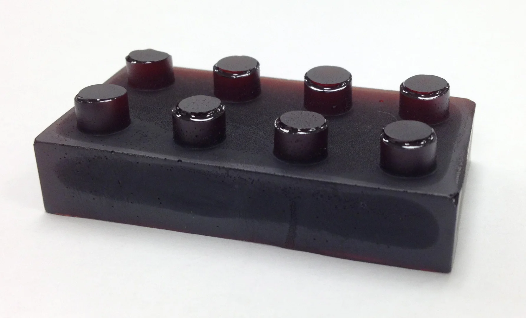 Sulfur-limonene polymer is a plastic made from citrus peel (here shown molded into the shape of a plastic building block) that can both detect and absorb mercury pollution
