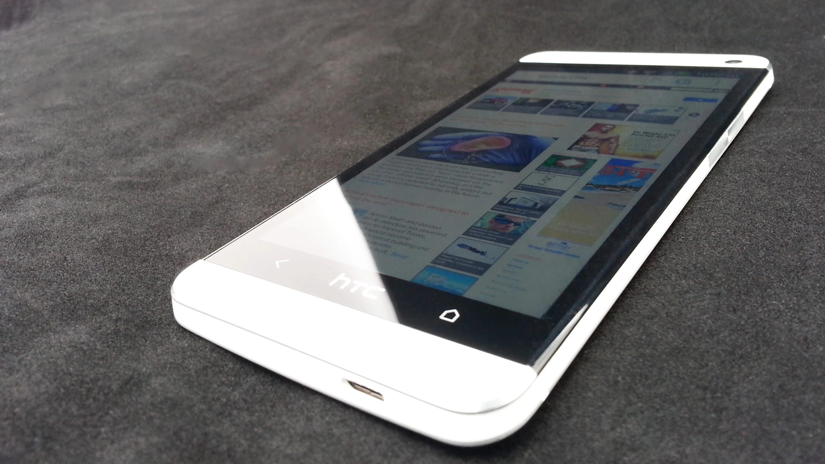Capacitive home and back buttons sit below the screen