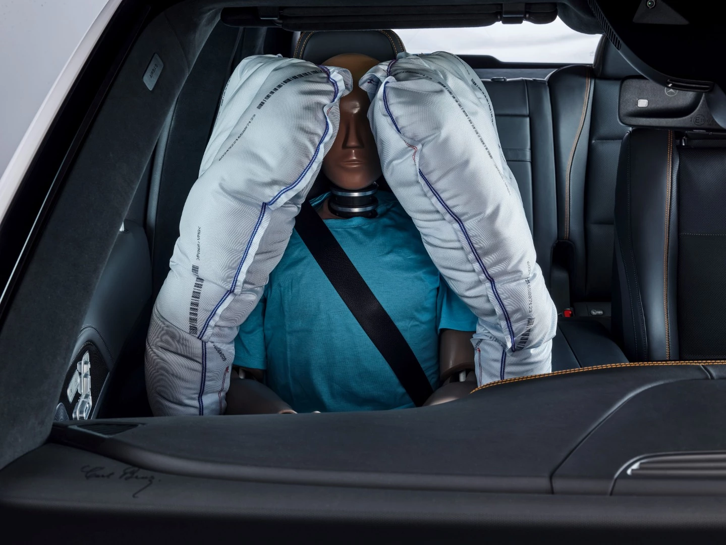 Side airbags fluff out from behind the front seats