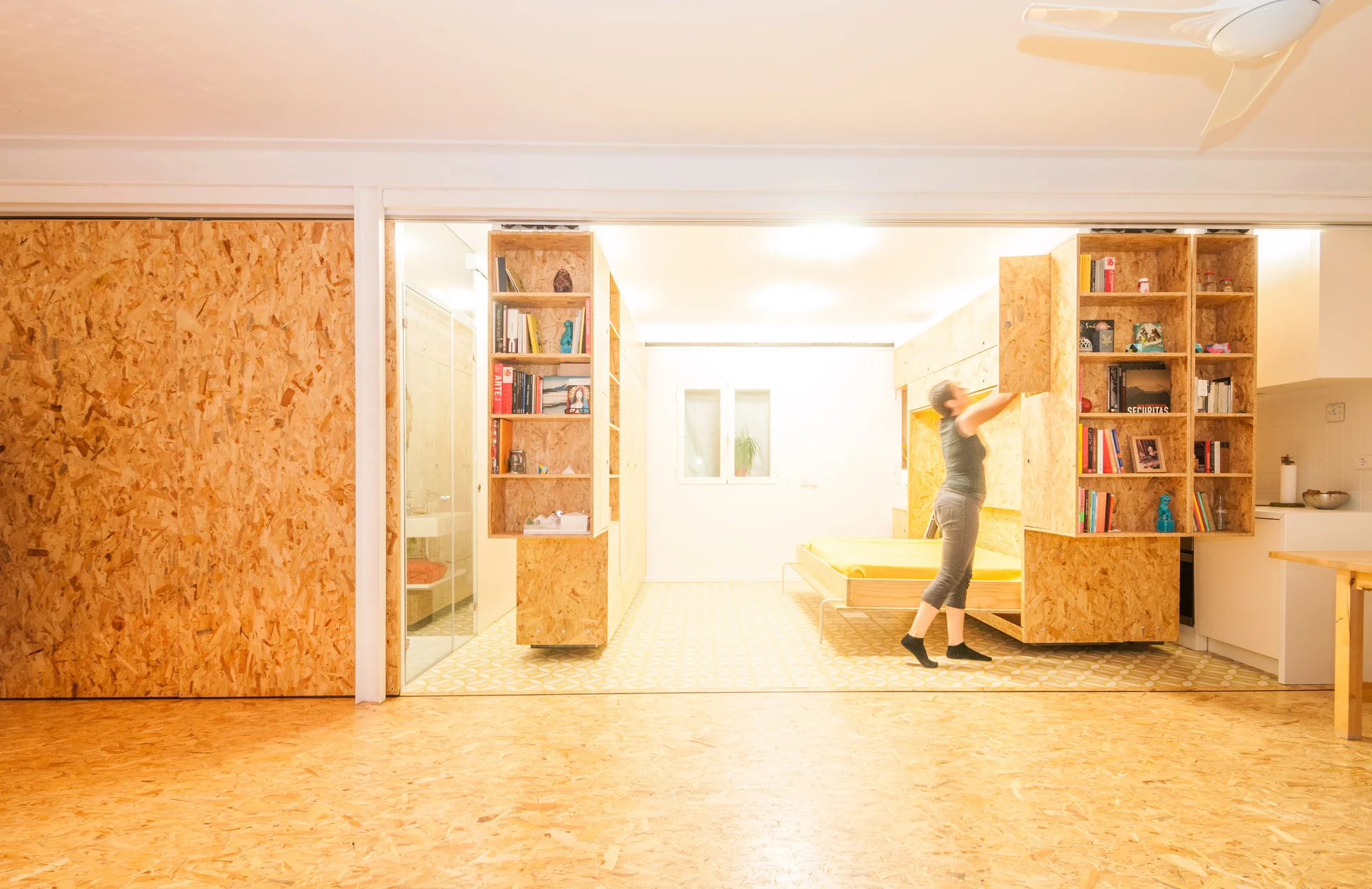 Rather than just sliding walls, the units also serve as bookshelves and storage, and sport a kitchen counter and bed too (Photo: Javier de Paz García)