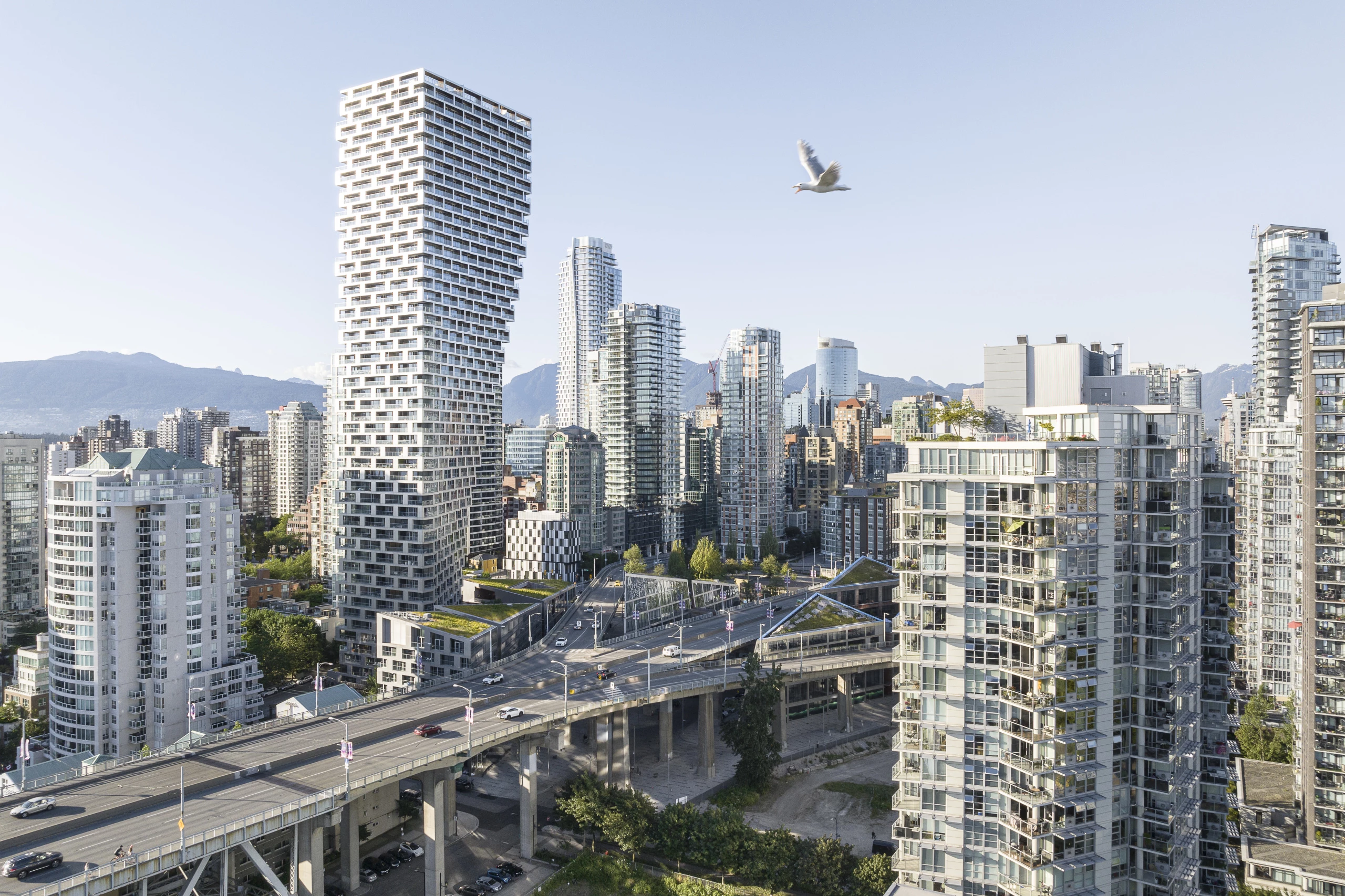 Vancouver House's unusual top-heavy form came about because local planning regulations state that the tower must be no less than 30 m (98 ft) from the nearby bridge until it reaches a height of 30 m (98 ft)