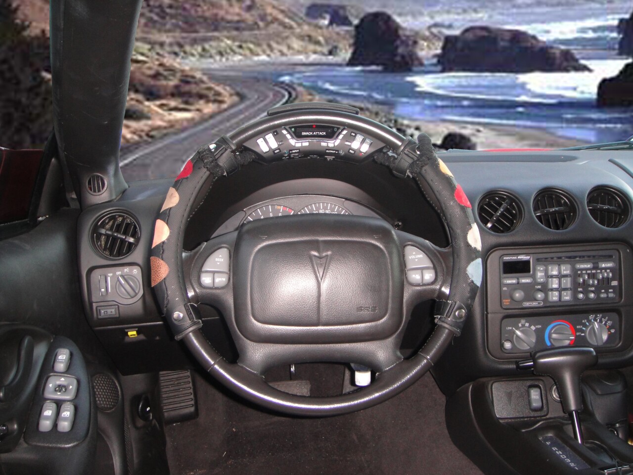 The cover will fit any steering wheel, and features eight color-coded smack sensors, each making a different drum sound when smacked