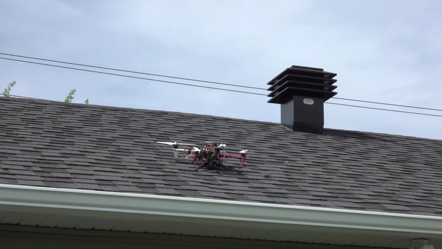 A drone nestles safely on a steep rooftop