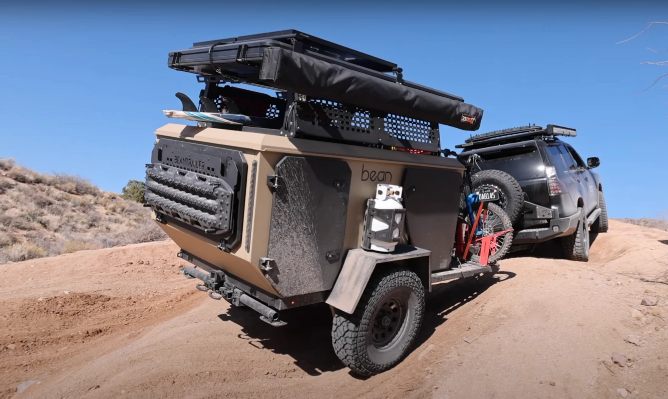 Something of a shrunken off-road squaredrop trailer, the Bean Pod sleeps gear instead of people, moving the human campers up top
