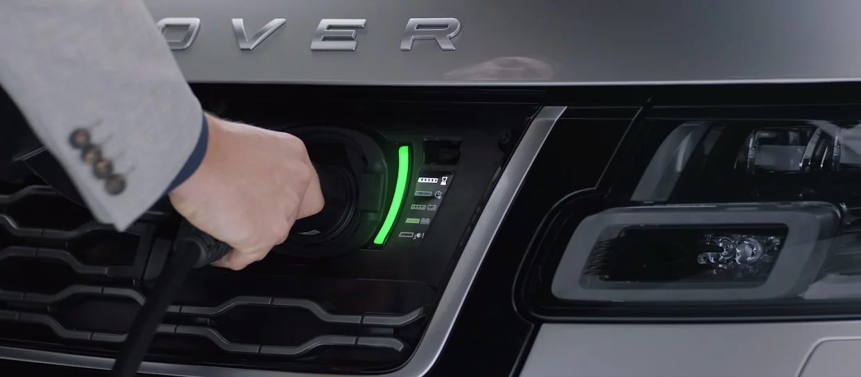 The recharge socket on the Range Rover P400e is hidden behind a Land Rover badge on the front grille