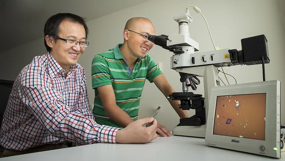 Dr Yuerui (Larry) Lu (right) says the development of the world’s thinnest lens could lead to the miniaturization of optical components