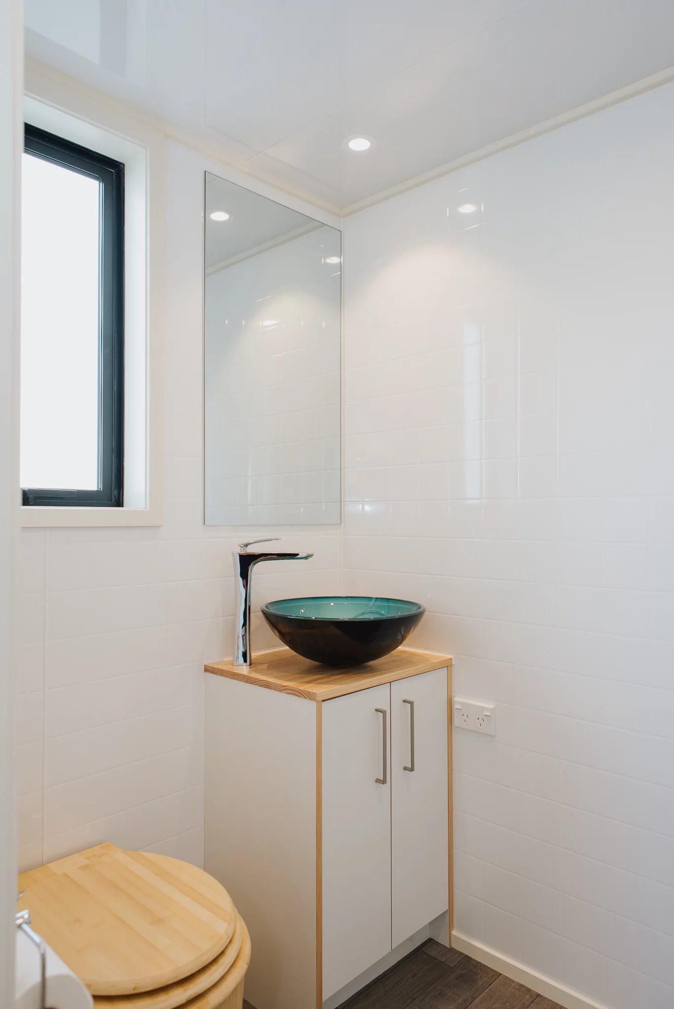 The Daisy Vera Tiny House's bathroom includes a vanity sink unit