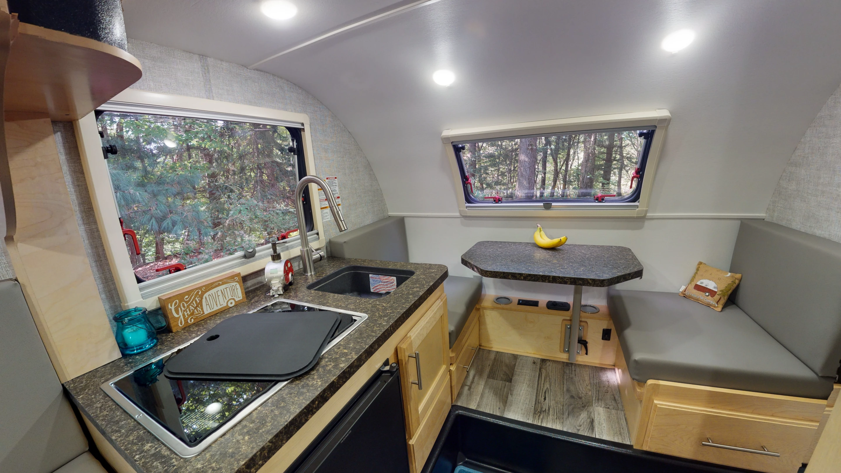 The Little Guy Micro Max teardrop trailer has a lowered floor for kitchen usage and a two-person front dinette/convertible single bed
