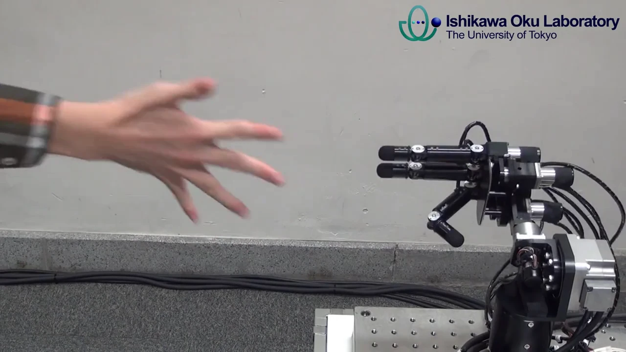 The Ishikawa Oku Lab's robot hand sticks out two fingers (scissors), beating the human (paper) in about one millisecond