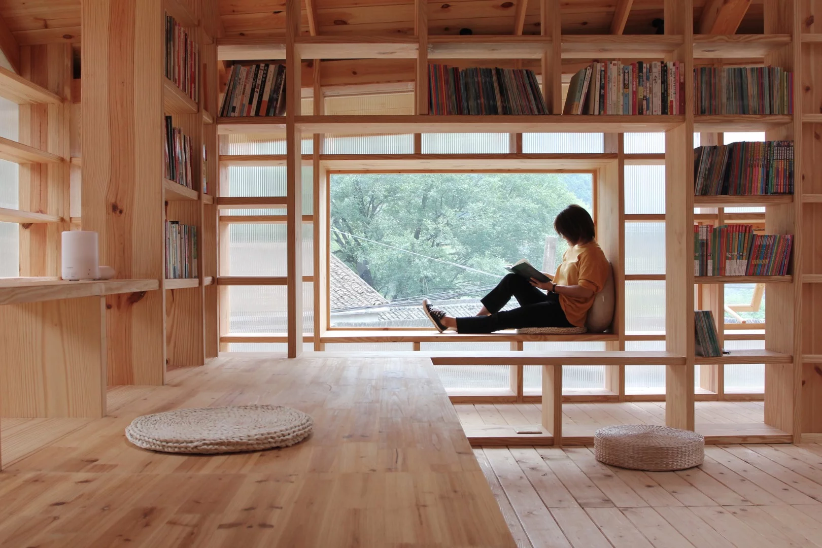 The raised building is located near to a children's playground and parents can sit, book in hand, while keeping an eye on their kids through the windows
