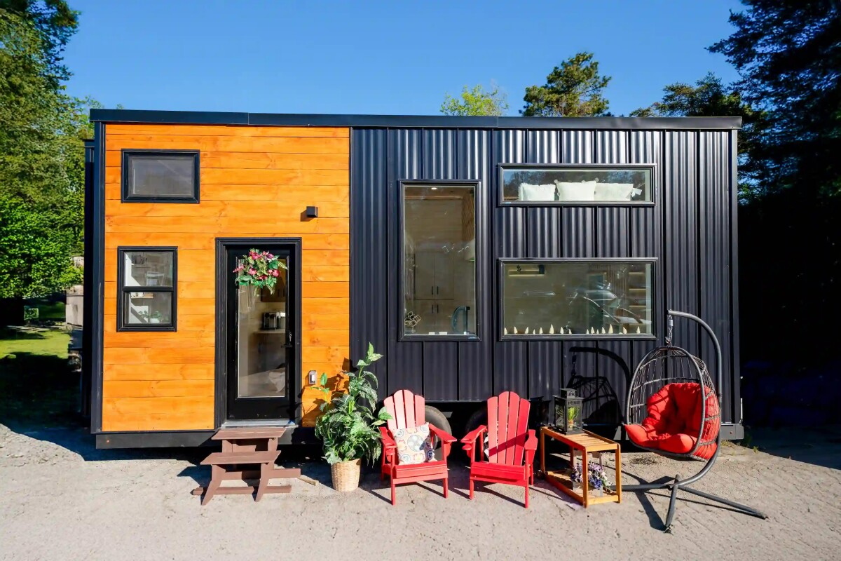 Compact tiny house fits two bedrooms and a surprisingly useful kitchen