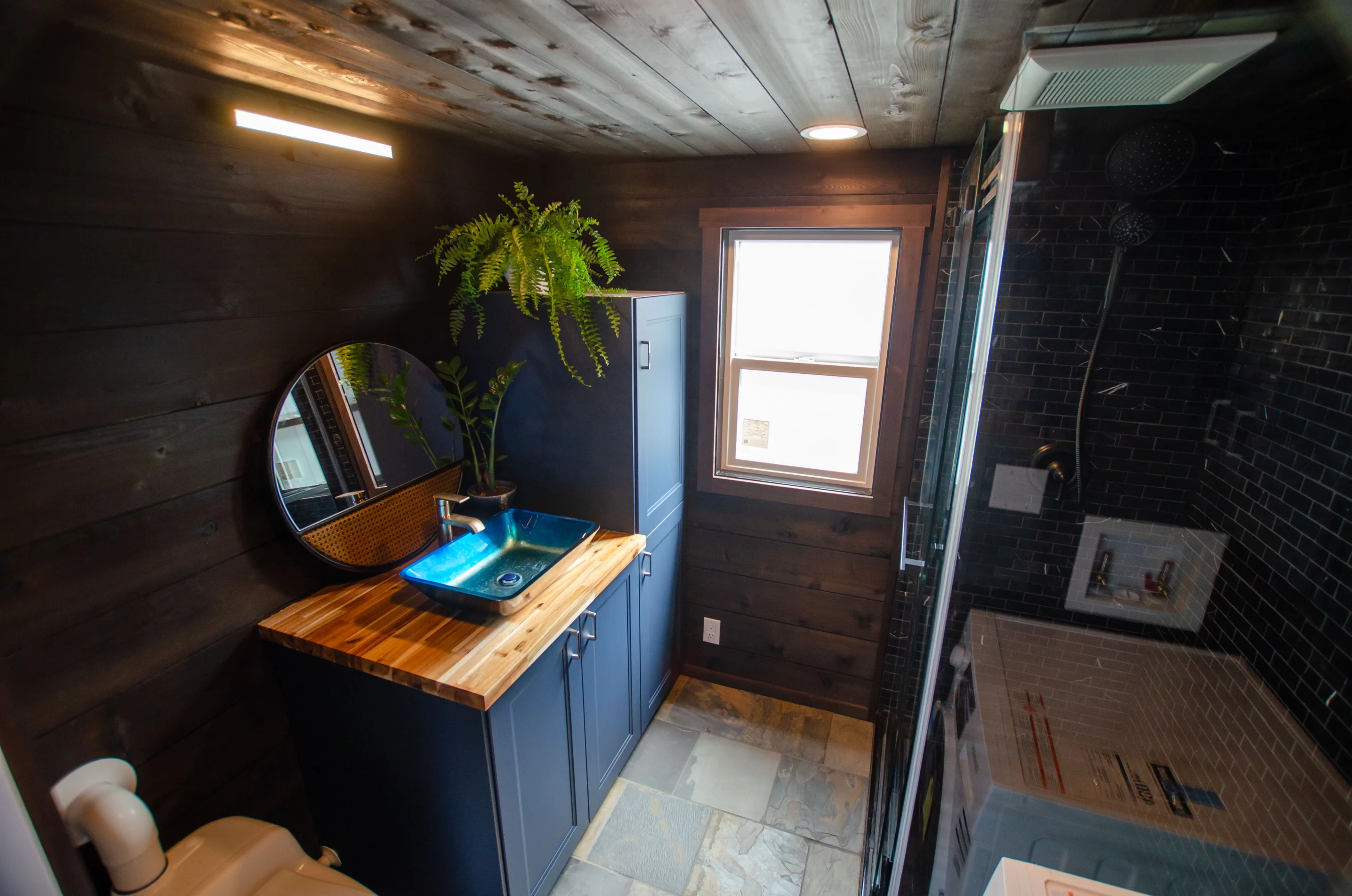 The Raven's bathroom contains a shower, sink, and a composting toilet