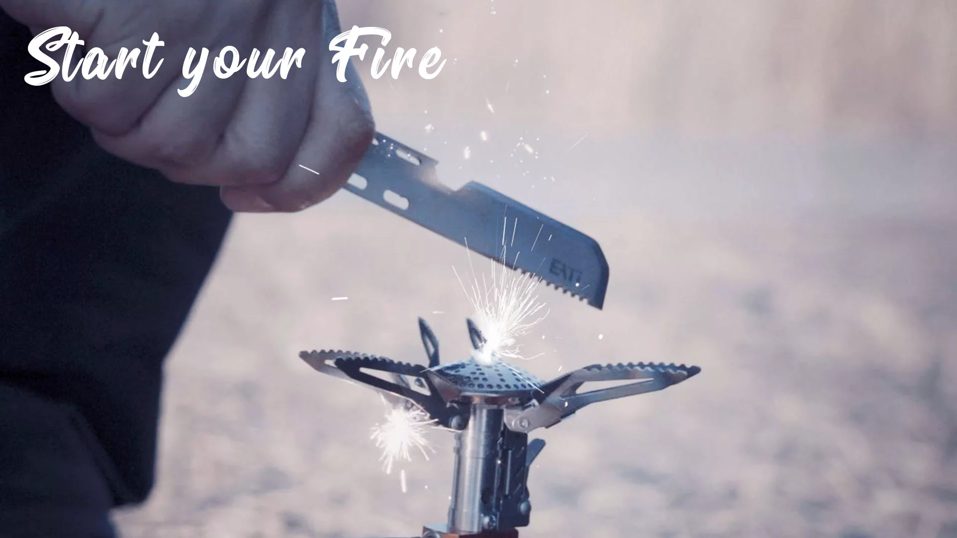 Use the EATI knife with a fire starter to spark a flame