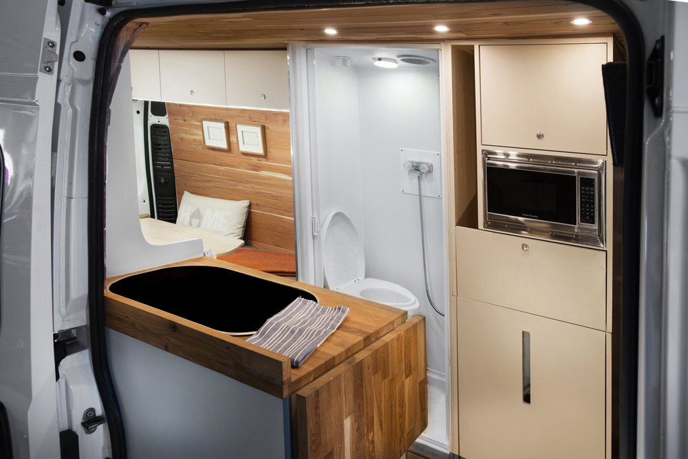 Off Grid has managed to squeeze a bathroom with shower and available toilet into its van