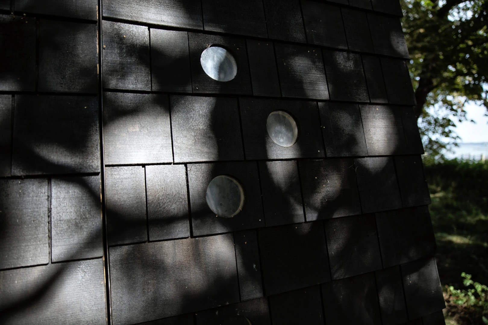 Each of the asymmetrical shelters sports small porthole-like lookouts