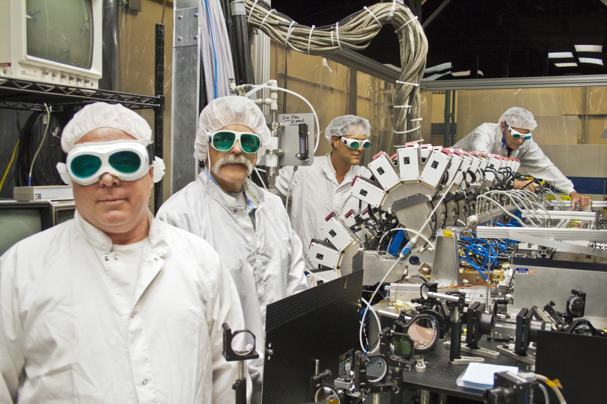 Boeing Thin Disk Laser engineers and the laser's main optical bench (Photo: Boeing)