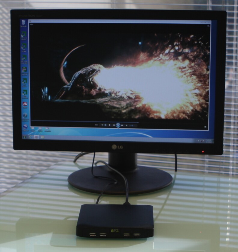 The new fit-PC3 connected to a monitor and playing an HD movie