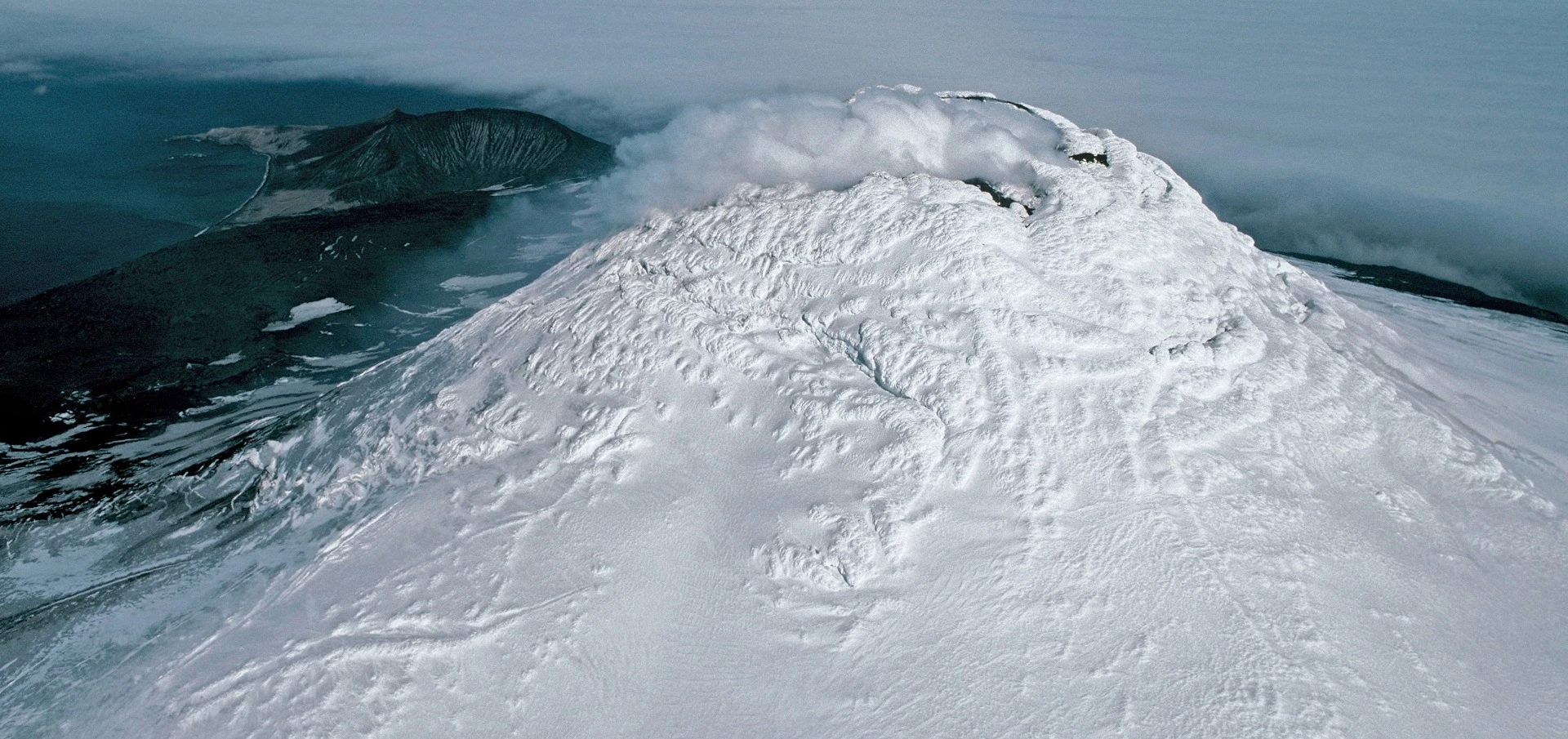 Aerial photograph of Mount Michael and its volcanic plume