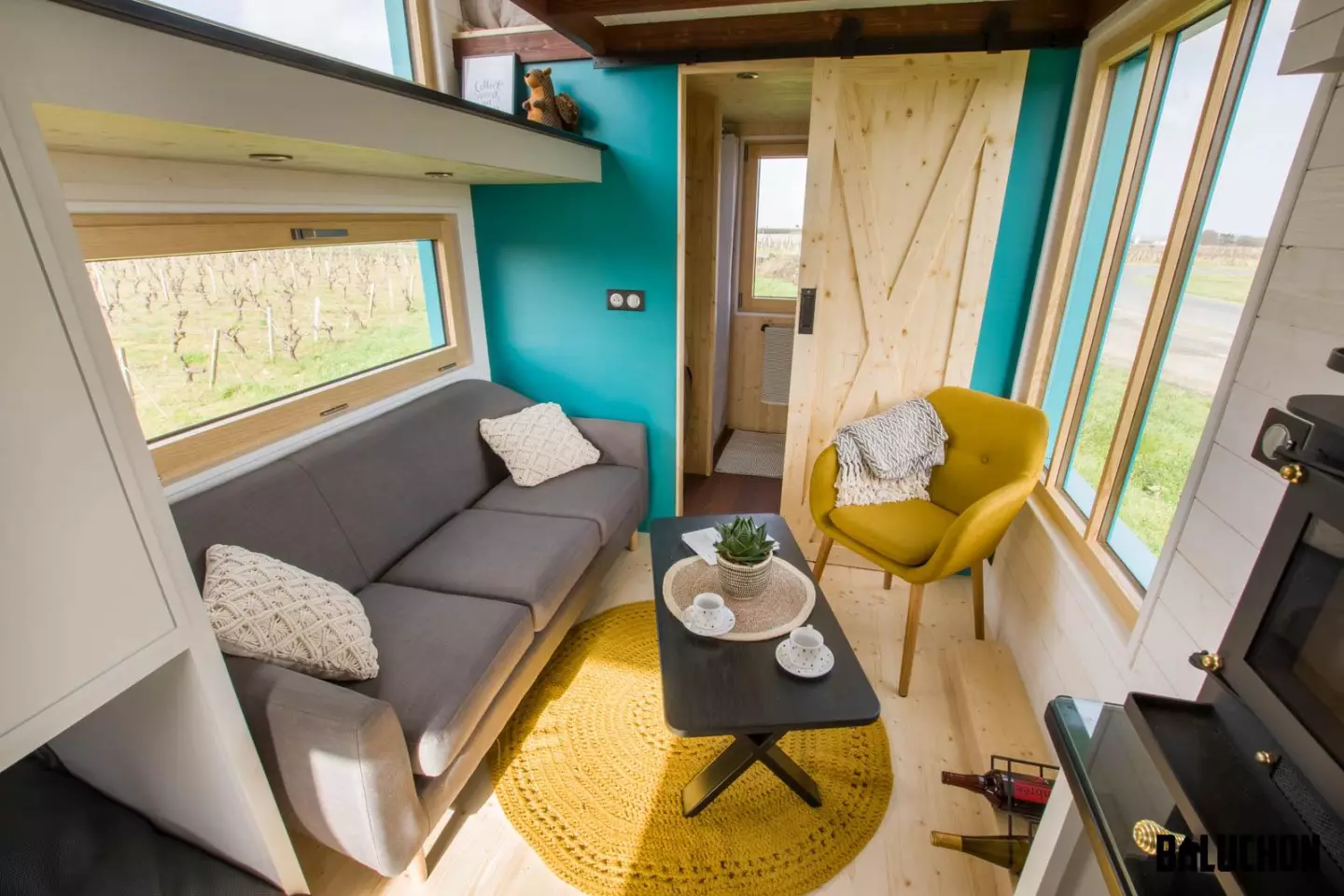The Téméraire's living room includes a sofa, coffee table, and a chair