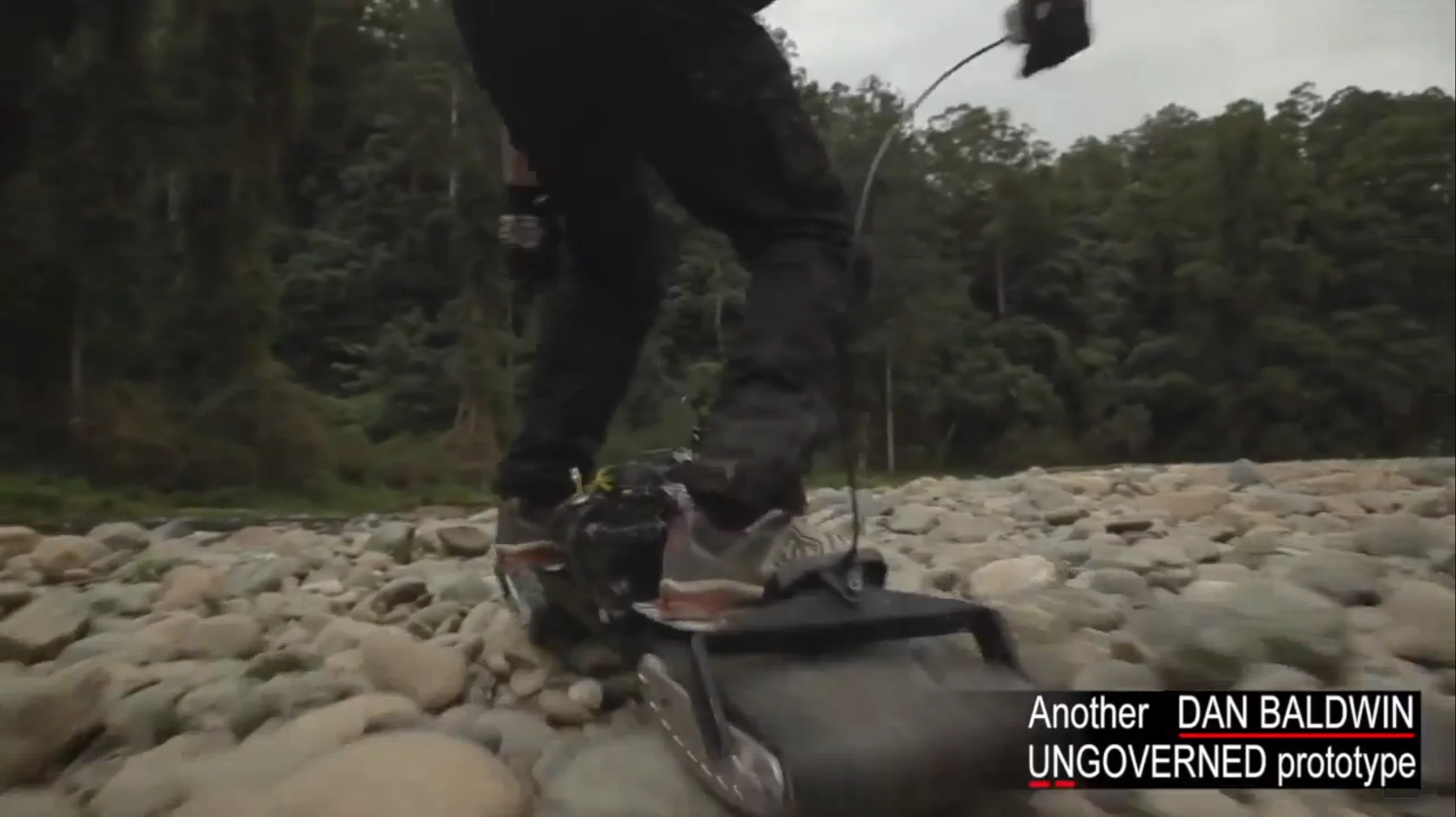 The Ungoverned powerboard motors over some rocks