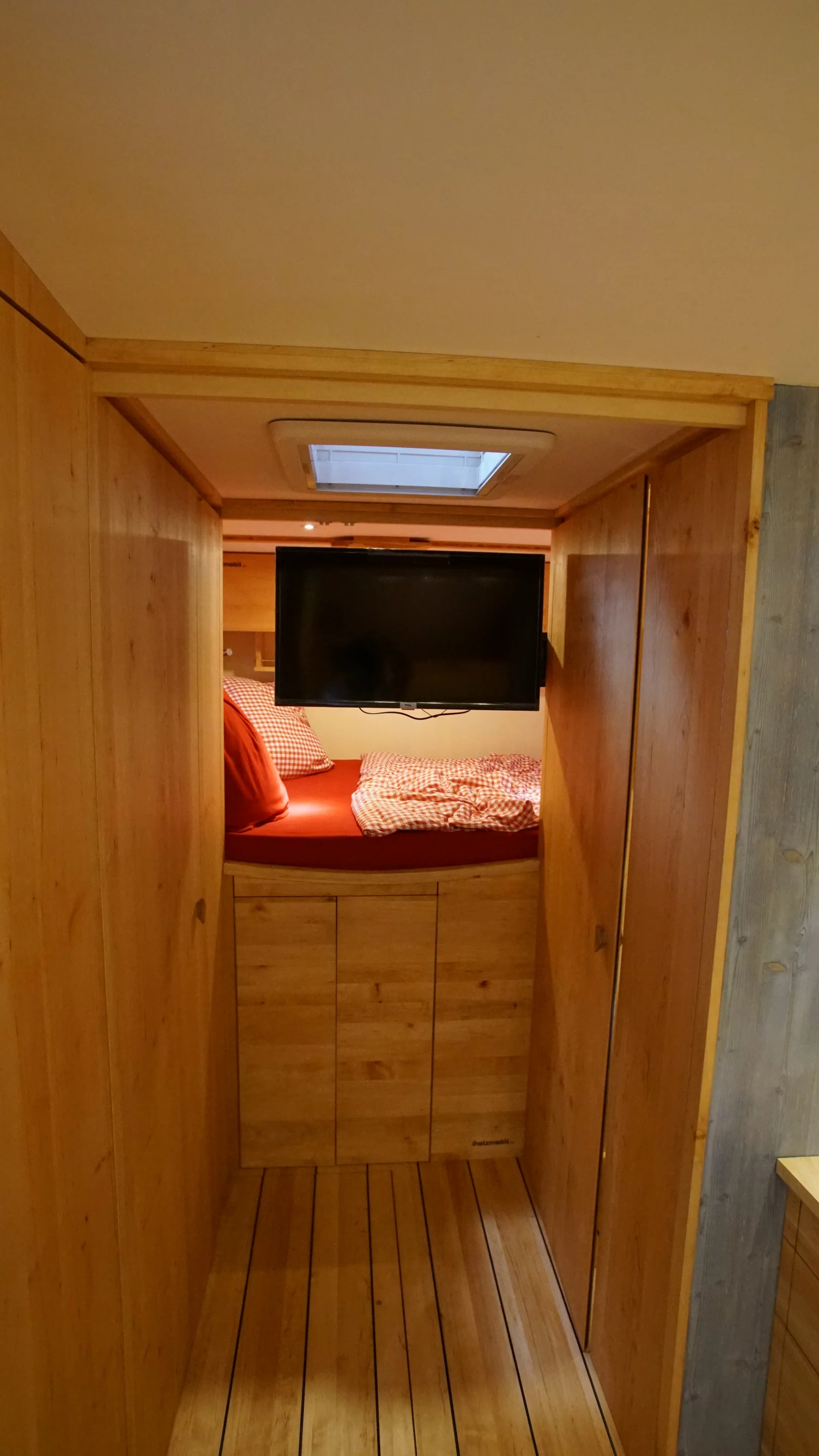 A swivel-mounted TV can be viewed from the bed or living area