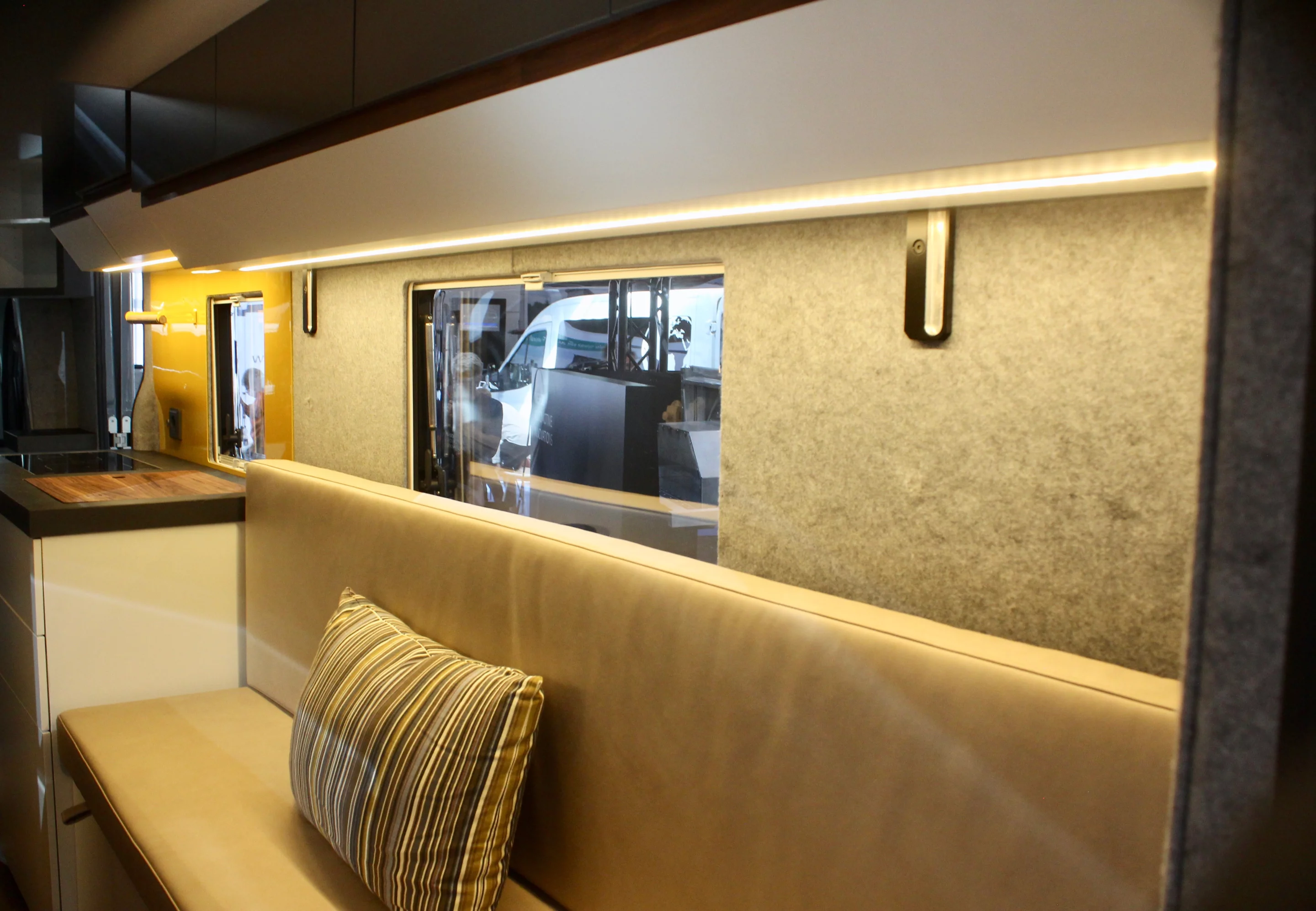 Walnut trim, fabric wall paneling and ambient lighting help make the NEXSD One a warm space